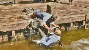 Charles Smith falls into the water along with the enemy