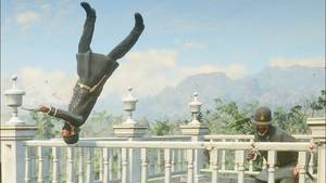 A policeman does a somersault while jumping over the railing